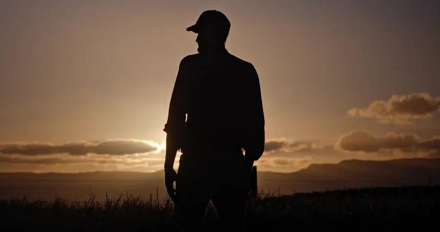 Tasmanian Farmer Standing at Sunset