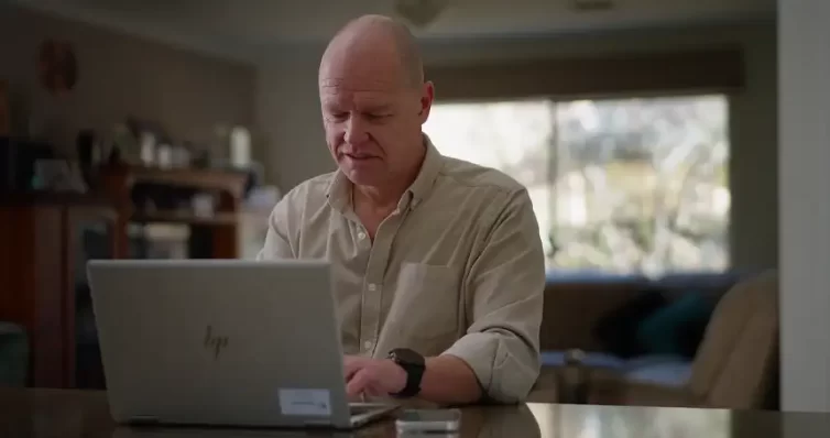 man sitting on laptop